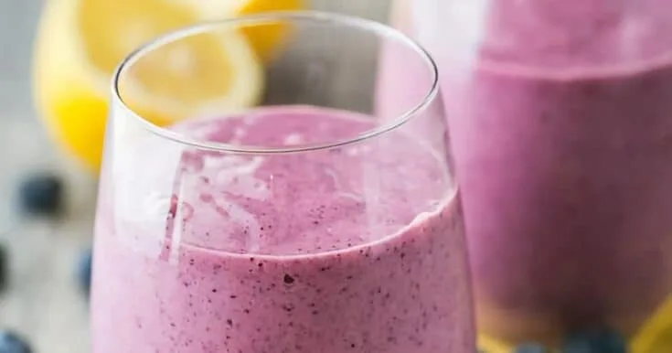 Blueberry Mango Detox Smoothie 8 Detox Blueberry Mango smoothie in a glass, on my kitchen counter, surrounded by fresh fruit and vegetables.