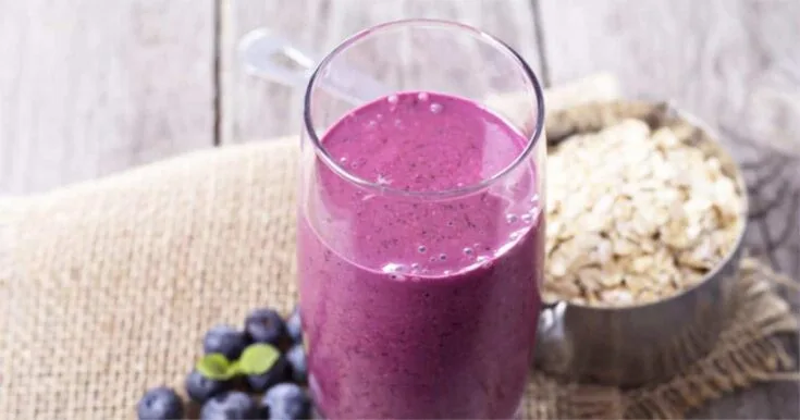 Cholesterol-Lowering Blueberry Oat Smoothie 7 Cholesterol-Lowering Blueberry Oat smoothie in a glass, on my kitchen counter, surrounded by fresh fruit and vegetables.