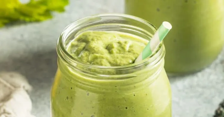 Cholesterol-Lowering Green Detox Smoothie 7 Cholesterol-Lowering Green Detox smoothie in a glass, on my kitchen counter, surrounded by fresh fruit and vegetables.