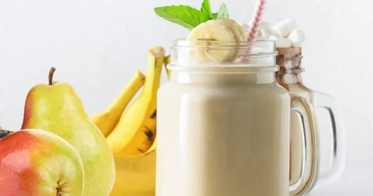 Cholesterol-Lowering Pear Ginger Smoothie 7 Cholesterol-Lowering Pear Ginger smoothie in a glass, on my kitchen counter, surrounded by fresh fruit and vegetables.