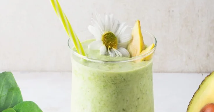 Cholesterol-Lowering Spinach Mango Smoothie 7 Cholesterol-Lowering Spinach Mango smoothie in a glass, on my kitchen counter, surrounded by fresh fruit and vegetables.