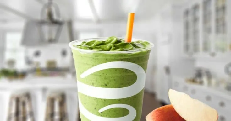 Jamba Juice Apple-N-Greens Smoothie 8 Jamba Juice Apple-N-Greens smoothie in a glass, on my kitchen counter, surrounded by fresh apple slices and greens.