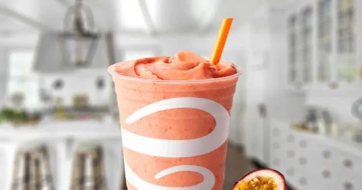 Jamba Juice Caribbean Passion Smoothie 8 Jamba Juice Caribbean Passion smoothie in a glass, on my kitchen counter, surrounded by fresh passion fruit.
