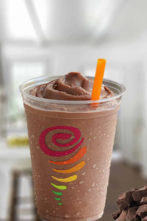 Jamba Juice Chocolate Moo'd smoothie in a glass, on my kitchen counter, surrounded by chunks of dark chocolate.