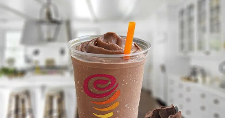 Jamba Juice Chocolate Moo'd Smoothie 4 Jamba Juice Chocolate Moo'd smoothie in a glass, on my kitchen counter, surrounded by chunks of dark chocolate.