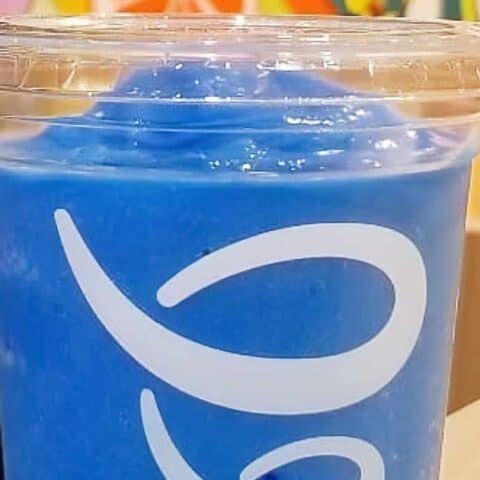 Jamba Juice Secret Menu Blue Topia smoothie in a glass, at the store.