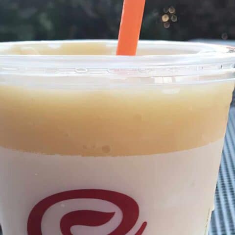 Jamba Juice Secret Menu Peaches And Cream smoothie in a glass, outdoors.