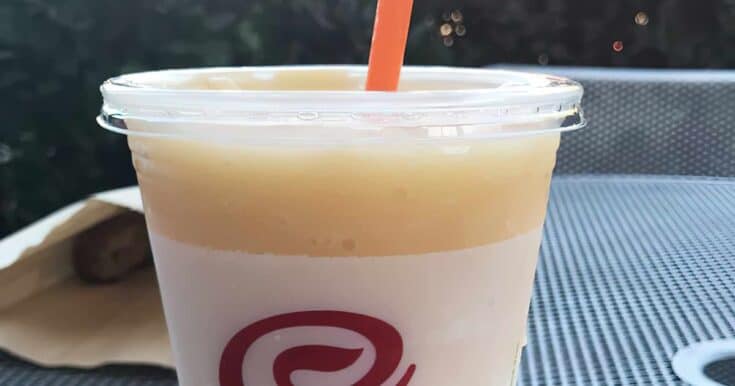 Jamba Juice Secret Menu Peaches And Cream smoothie in a glass, outdoors.