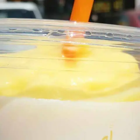 Jamba Juice Secret Menu Pineapple Dreamin' smoothie in a glass, at the store.