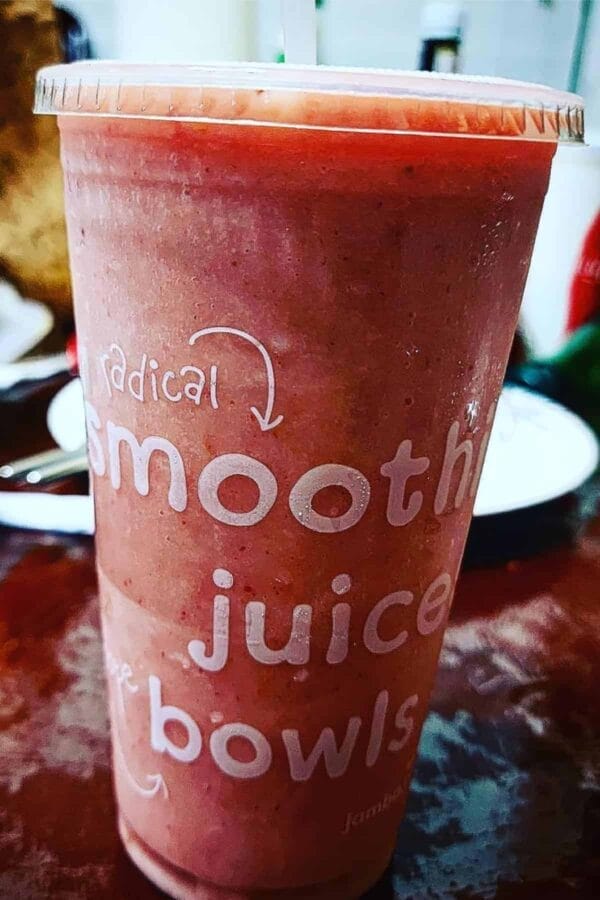Jamba Juice Secret Menu Raspberry Dream Machine smoothie in a glass, on my kitchen counter.