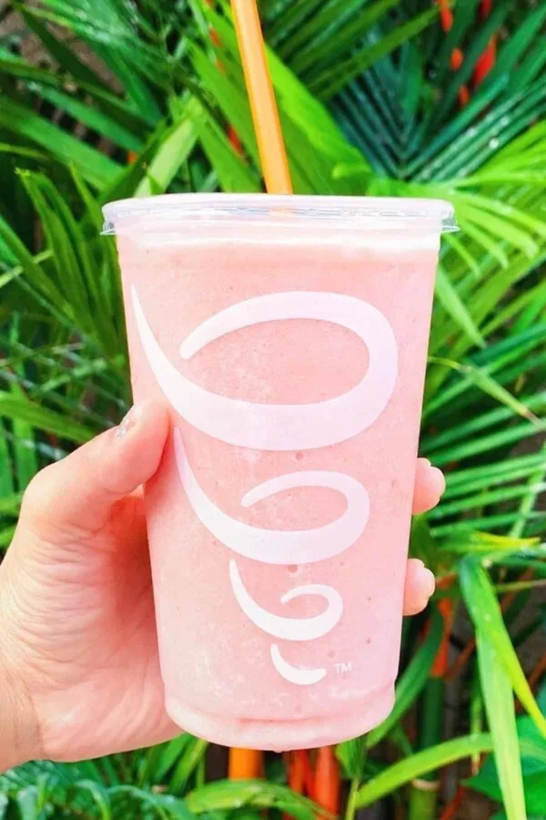Jamba Juice Secret Menu Strawberry Dream Machine Smoothie 1 Jamba Juice Secret Menu Strawberry Dream Machine smoothie in a glass, outdoors.