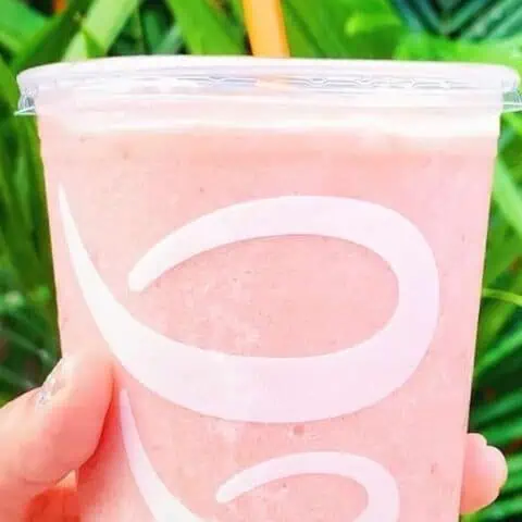 Jamba Juice Secret Menu Strawberry Dream Machine smoothie in a glass, outdoors.