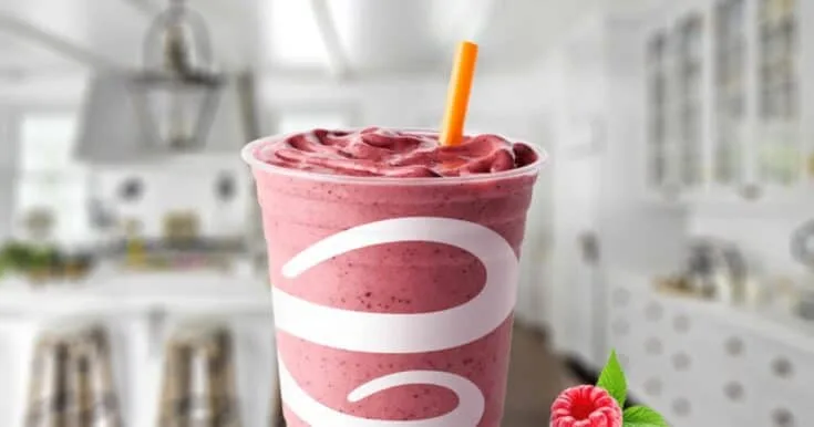 Jamba Juice Strawberry Raspberry Banana Smoothie 7 Jamba Juice Strawberry Raspberry Banana smoothie in a glass, on my kitchen counter, surrounded by fresh berries and banana slices.