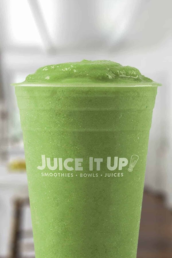 Juice It Up Ever Green smoothie in a glass, on my kitchen counter.