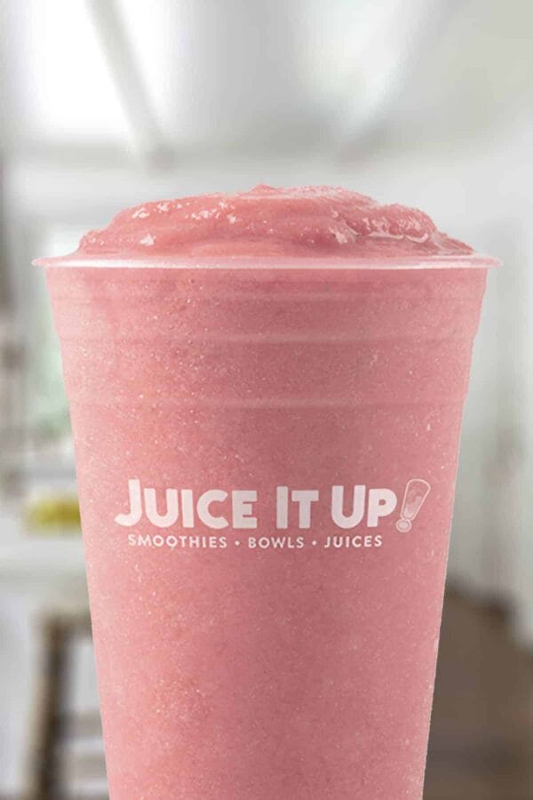 Juice It Up Strawberry Wave smoothie in a glass, on my kitchen counter.