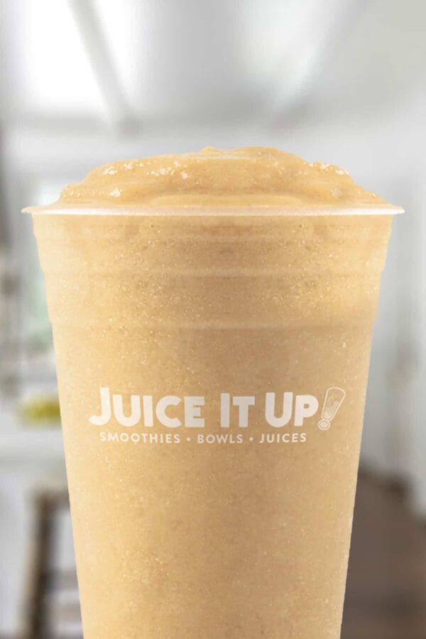 Juice It Up Superfruit Sunrise smoothie in a glass, on my kitchen counter.