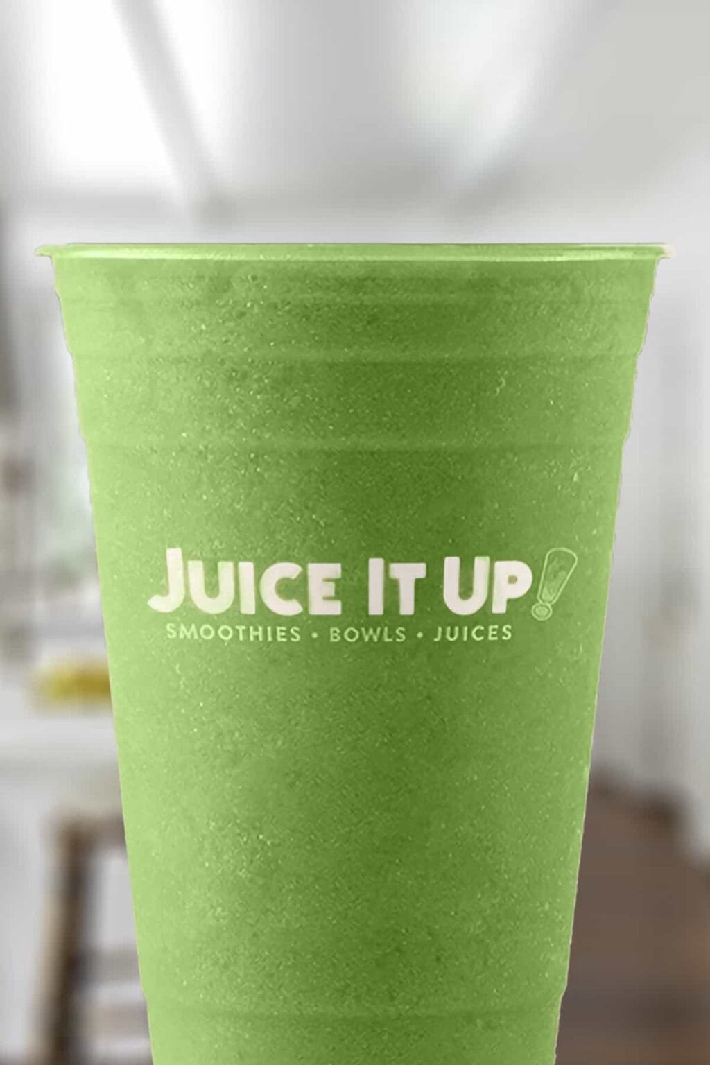 Juice It Up The Greens smoothie in a glass, on my kitchen counter.