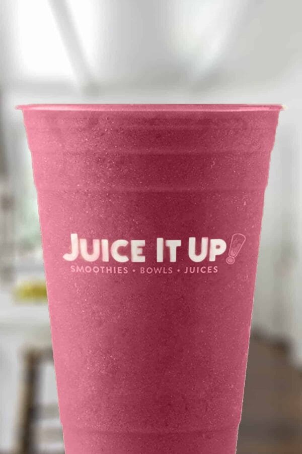 Juice It Up The Reds smoothie in a glass, on my kitchen counter.
