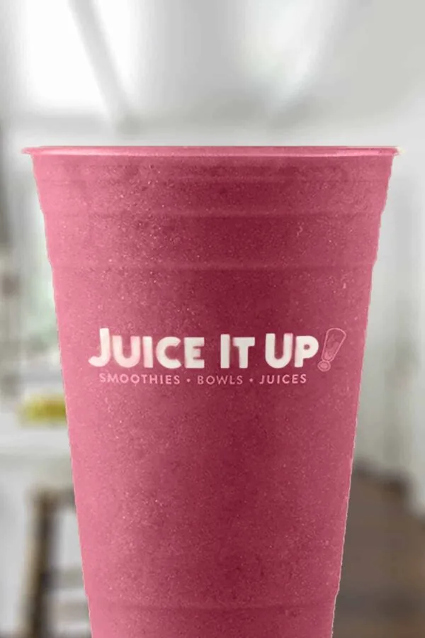 Juice It Up The Reds smoothie in a glass, on my kitchen counter.