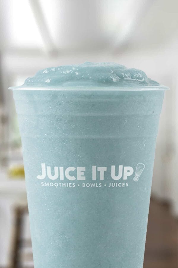 Juice It Up Vital Proteins Blue smoothie in a glass, on my kitchen counter.