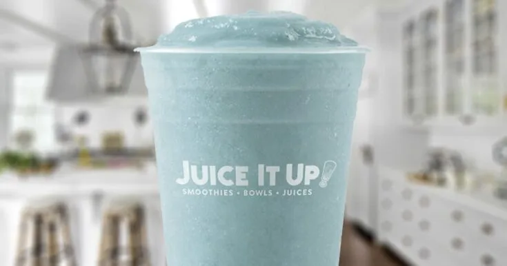 Juice It Up Vital Proteins Blue smoothie in a glass, on my kitchen counter.