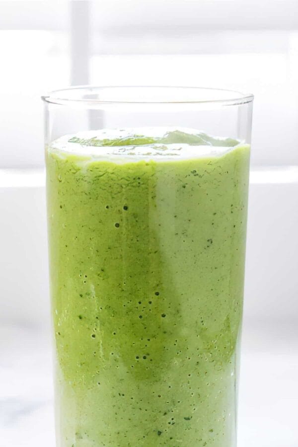 NutriBullet Cleansing Green smoothie in a glass, on my kitchen counter.