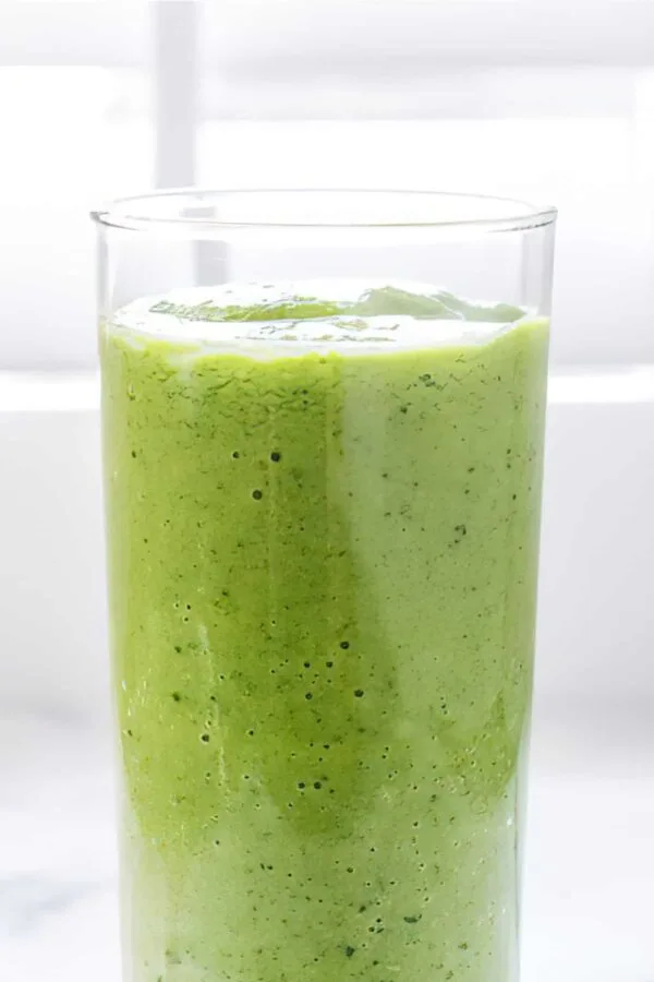 NutriBullet Cleansing Green smoothie in a glass, on my kitchen counter.