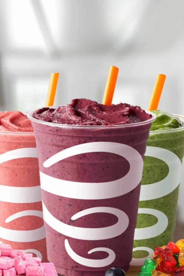 Jamba Juice Secret Menu smoothies in glasses, on my kitchen counter, surrounded by Pink Starburst candy and Gummi Bears.