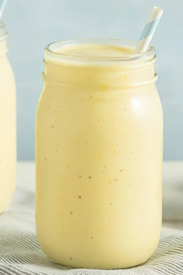 Ninja Blender Creamy Banana Orange Protein smoothie in a glass, on my kitchen counter.