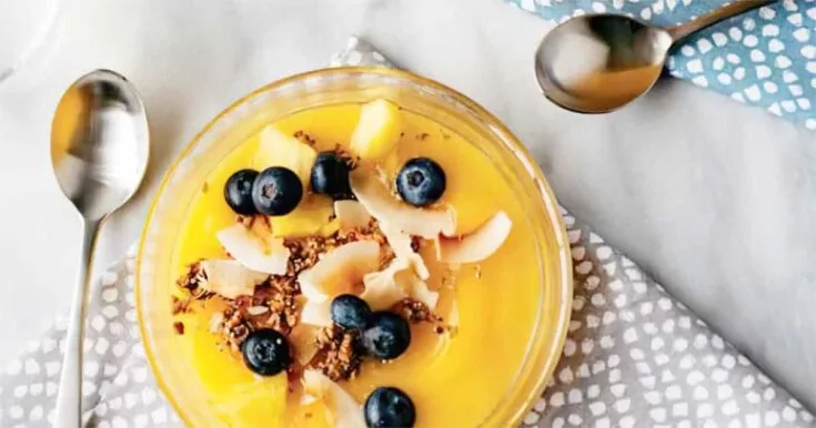 Ninja Blender Mango Coconut smoothie in a glass, on my kitchen table.