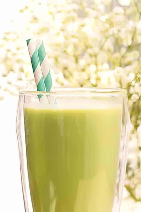 Ninja Blender Vanilla Matcha Protein smoothie in a glass, on my kitchen table.