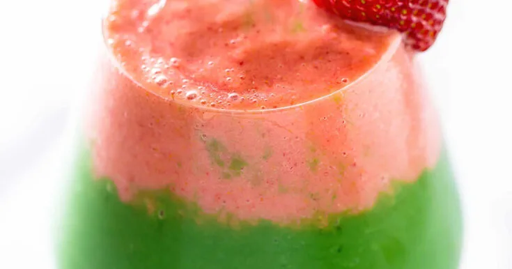 NutriBullet Berry Green Layered Smoothie 11 NutriBullet Berry Green Layered smoothie in a glass, on my kitchen counter, topped with a strawberry garnish.