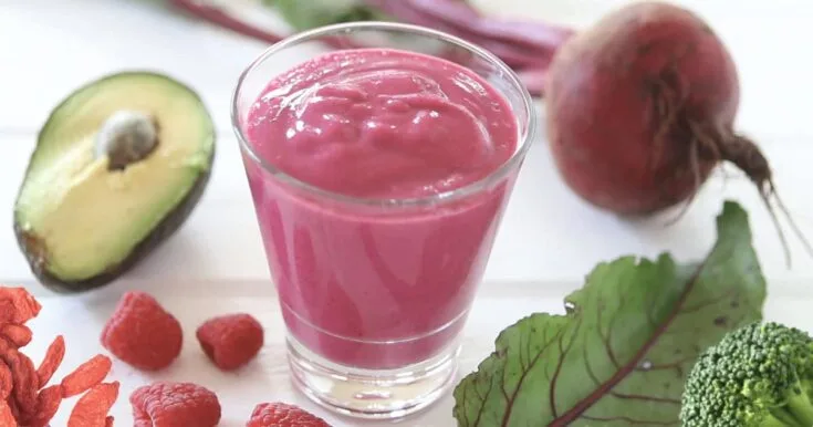 NutriBullet Hormone Helper Smoothie 9 NutriBullet Hormone Helper smoothie in a glass, on my kitchen counter, surrounded by fresh fruit and vegetables.