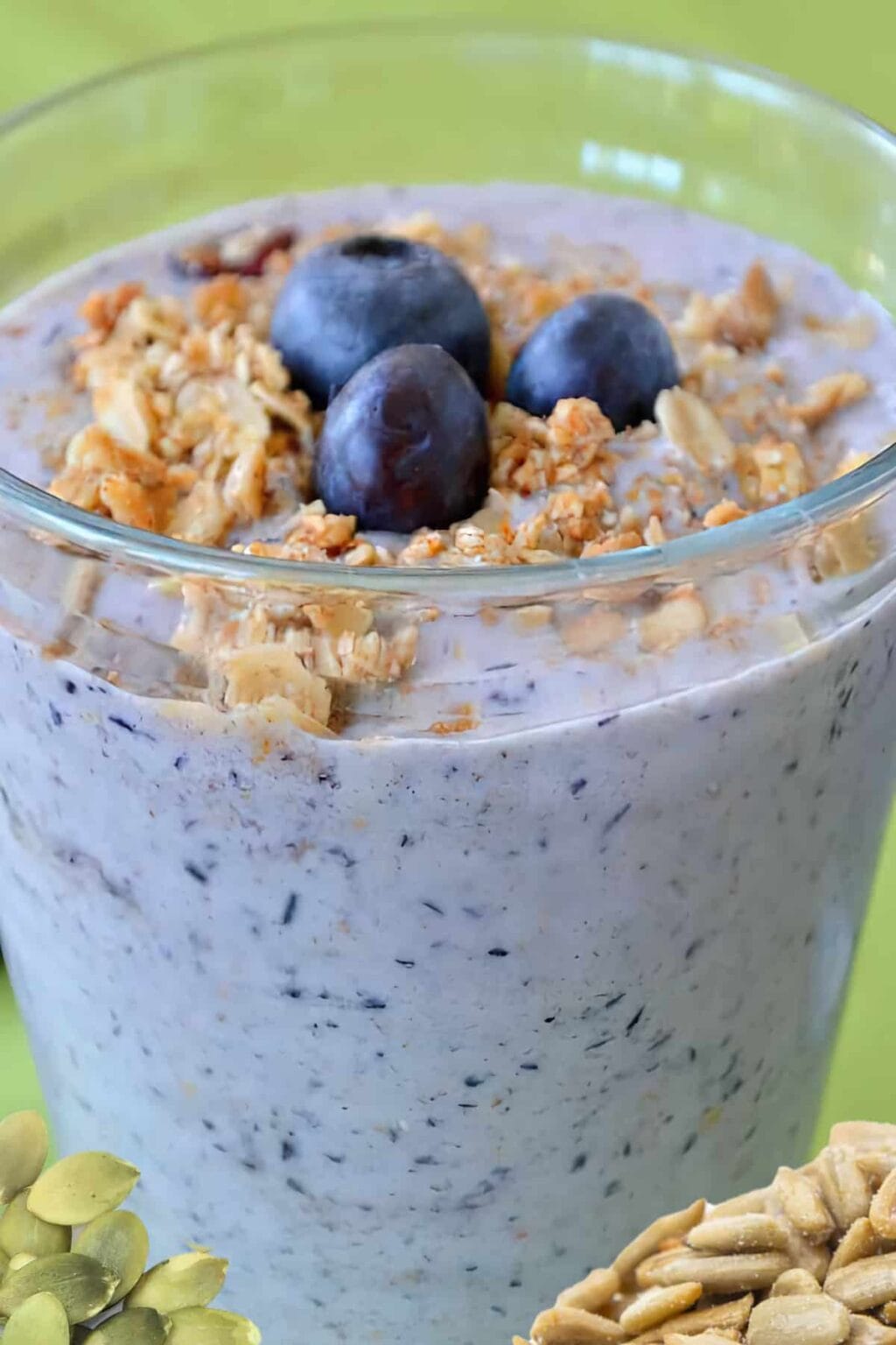 NutriBullet Sleepy Seeds smoothie in a glass, on my kitchen counter, surrounded by fresh berries.