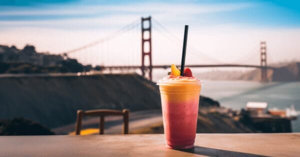 BetterBlends AI generated smoothie in a glass, on a table outdoors, with the Golden Gate Bridge in the background.