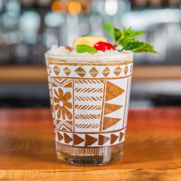 Cocktail in a high-ball glass, on a bar.