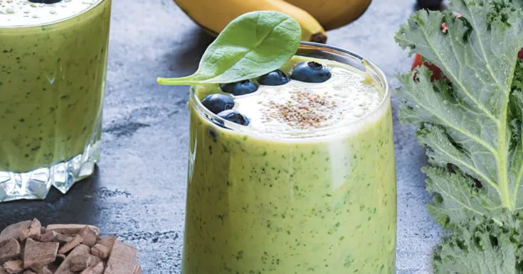 NutriBullet Cholesterol Crusher Blast Smoothie 8 NutriBullet Cholesterol Crusher Blast smoothie in a glass, on my kitchen counter, surrounded by fresh fruit and vegetables.