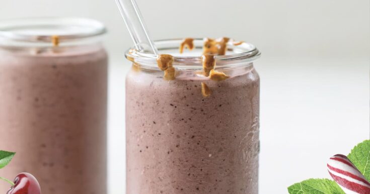 NutriBullet Pink Peppermint smoothie in a glass, on my kitchen counter, surrounded by fresh fruit.