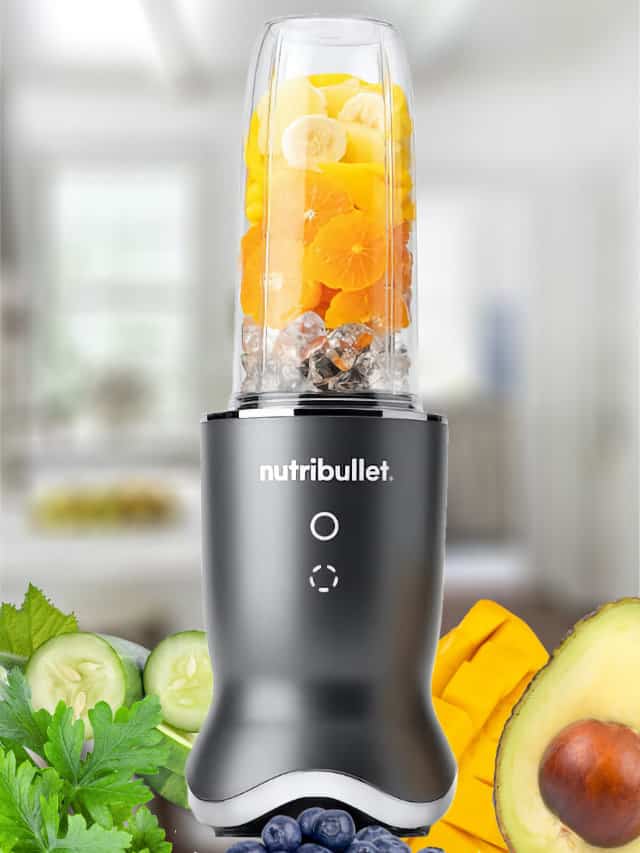 NutriBullet blender blending a NutriBullet smoothie, on my kitchen counter, surrounded by fresh fruit and vegetables.
