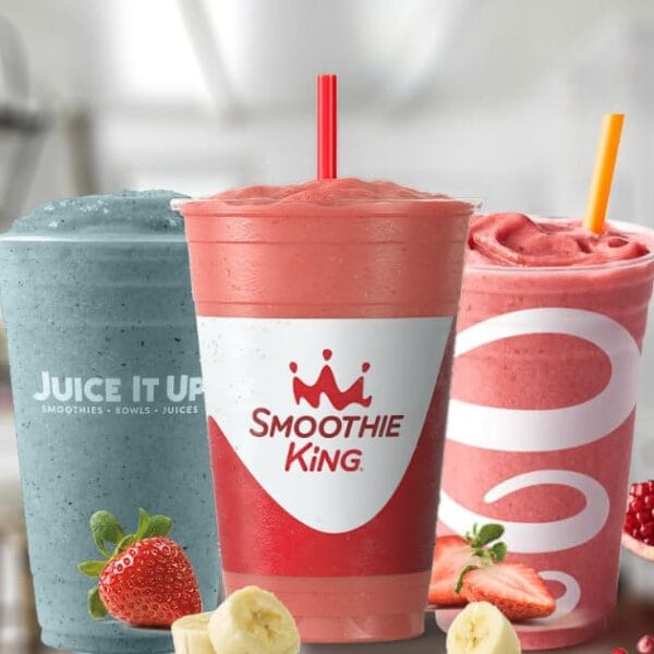 Smoothies in glasses, on my kitchen counter, surrounded by fresh fruit.