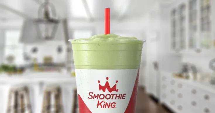 Smoothie King Collagen Power Pineapple Kale 9 Smoothie King Collagen Power Pineapple Kale smoothie in a glass, on my kitchen counter, surrounded by fresh pineapple and kale.