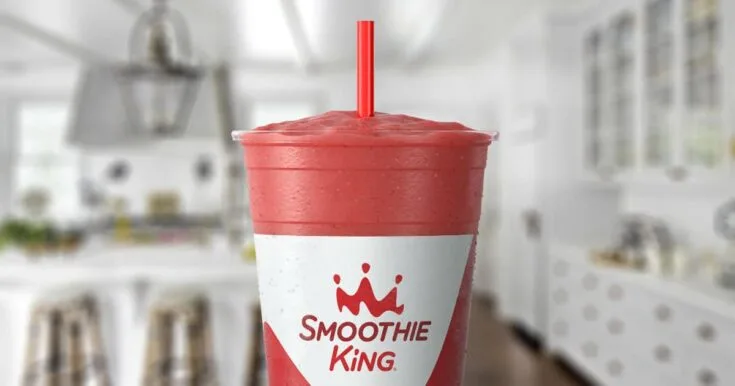 Smoothie King Immune Builder Mixed Berry 9 Smoothie King Immune Builder Mixed Berry smoothie in a glass, on my kitchen counter, surrounded by fresh berries and banana.