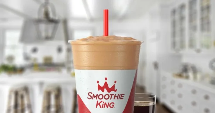 Smoothie King Gladiator Chocolate Coffee 6 Smoothie King Gladiator Chocolate Coffee smoothie in a glass, on my kitchen counter, surrounded by chocolate and a cup of coffee.