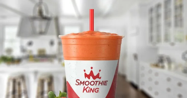Smoothie King Lemon Twist Strawberry 7 Smoothie King Lemon Twist Strawberry smoothie in a glass, on my kitchen counter, surrounded by fresh strawberries.