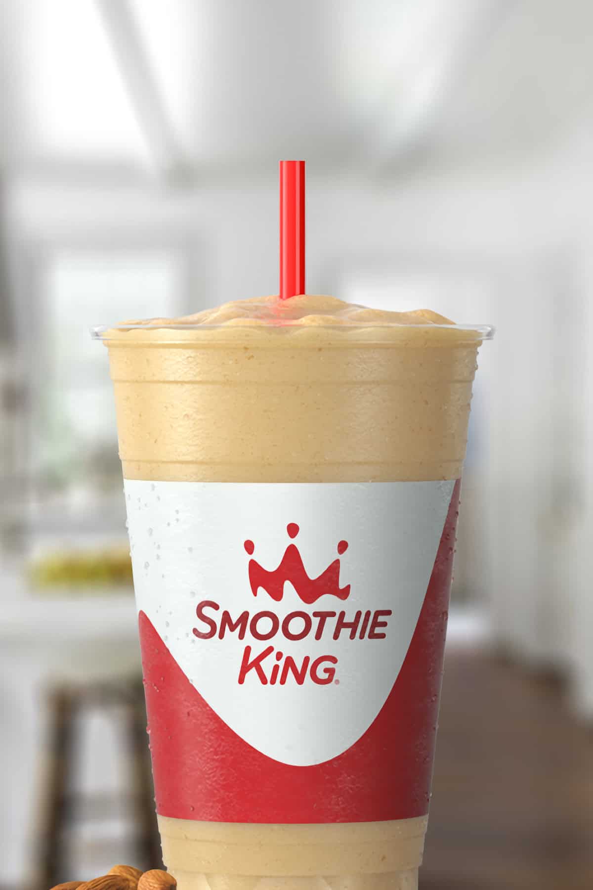 Smoothie King Original High Protein Lemon smoothie in a glass, on my kitchen counter, surrounded by almonds.