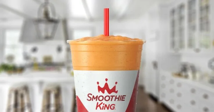 Smoothie King Pure Recharge Mango Strawberry 8 Smoothie King Pure Recharge Mango Strawberry smoothie in a glass, on my kitchen counter, surrounded by fresh strawberries and mangoes.