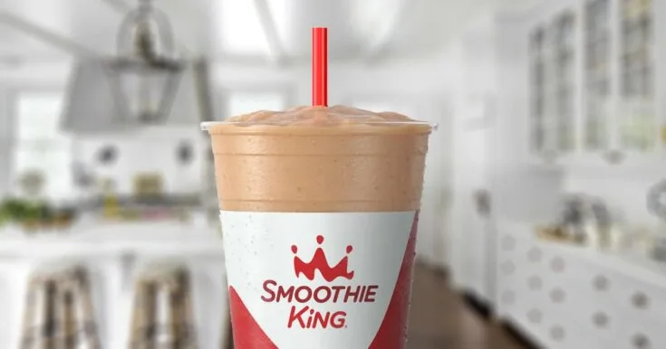 Smoothie King The Hulk Coffee 7 Smoothie King The Hulk Coffee smoothie in a glass, on my kitchen counter, surrounded by banana slices and coffee beans.