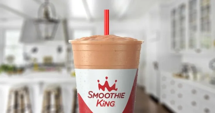 Smoothie King Yogurt D-Lite 6 Smoothie King Yogurt D-Lite smoothie in a glass, on my kitchen counter, surrounded by nonfat frozen yogurt.
