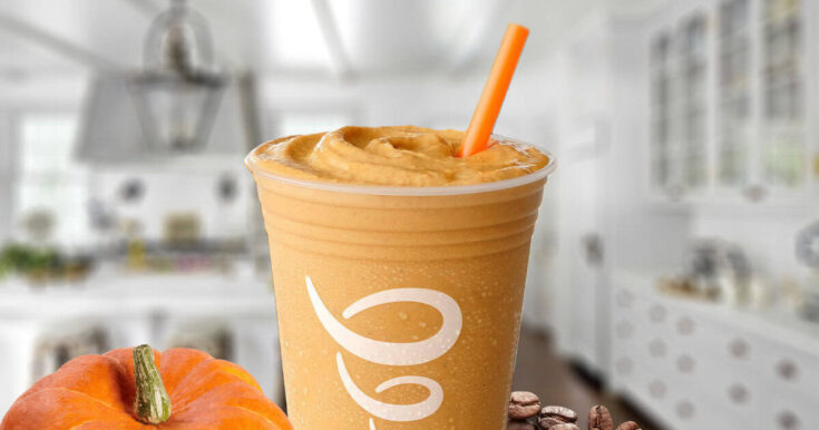 Jamba Juice Pumpkin Coffee smoothie in a glass, on my kitchen counter, surrounded by pumpkins and freshly roasted coffee beans.