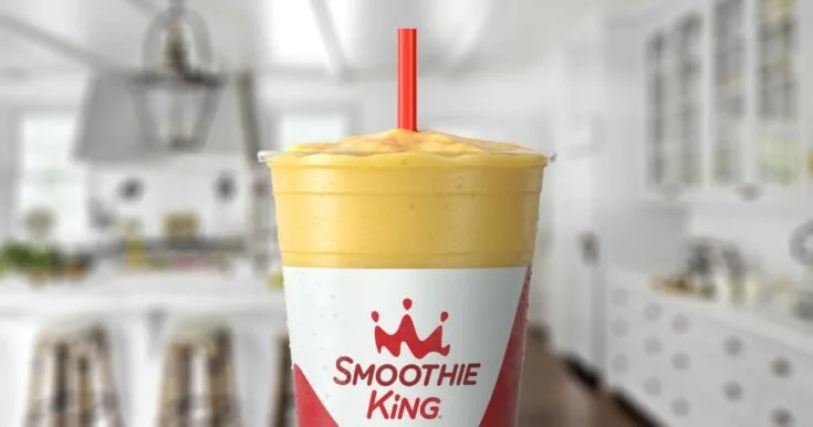 Smoothie King Slim-N-Trim Vanilla 5 Smoothie King Slim-N-Trim Vanilla smoothie in a glass, on my kitchen counter, surrounded by fresh sliced bananas.